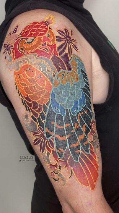 Colour bird with maple leaves, upper arm, tattoo by Dylan Block at Stingray Tattoo, Regina