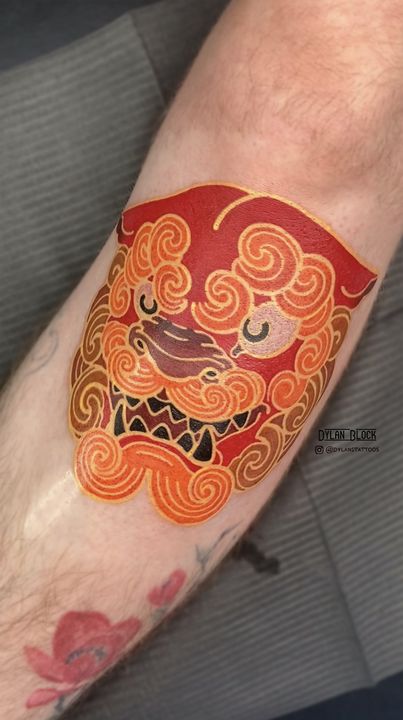 Foo dog head in orange and red, tattoo by Dylan Block at Stingray Tattoo, Regina