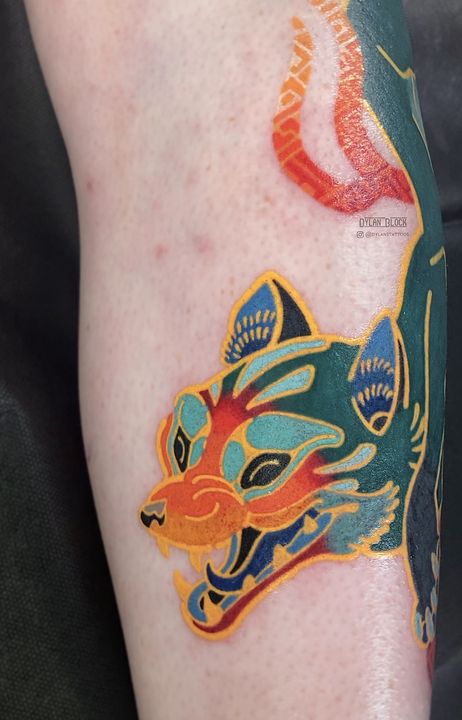 Teal fox with fire, calf, tattoo by Dylan Block at Stingray Tattoo, Regina