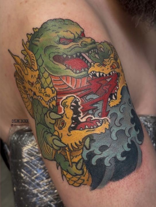 Green kaiju with waves, tattoo by Dylan Block at Stingray Tattoo, Regina