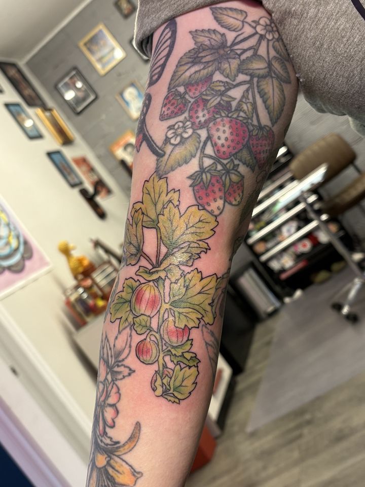 Strawberry vine sleeve in colour, tattoo by Lisa Loewen at Stingray Tattoo, Regina