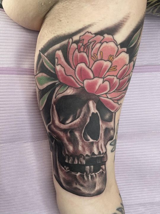 Skull and peony, thigh — tattoo at Stingray Tattoo, Regina